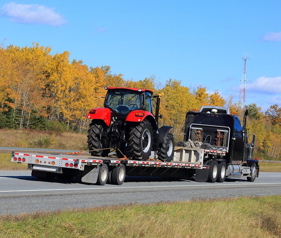 Red Tractor Being Transported